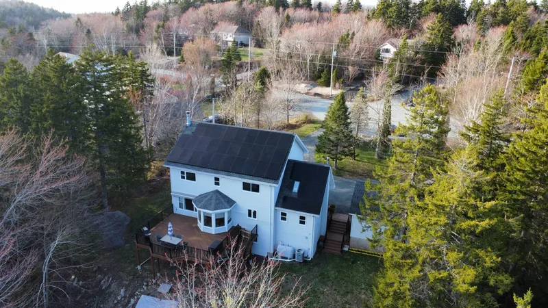 The Hammonds Plains home and its solar array seen from above the treeline
