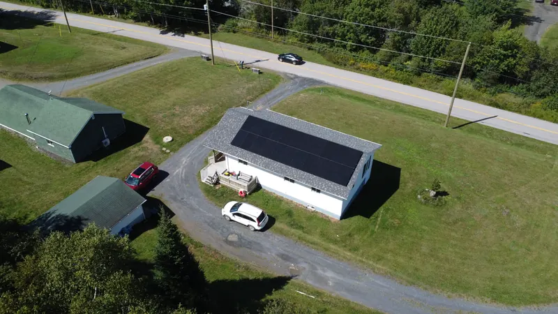 The Marshalltown property from above with the array, driveway and outbuildings