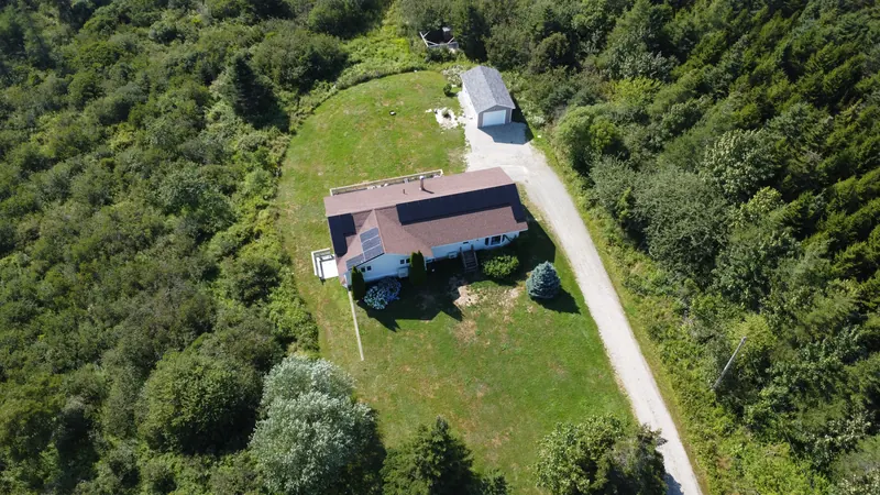 Wide aerial of the Saint Alphonse property and its long driveway