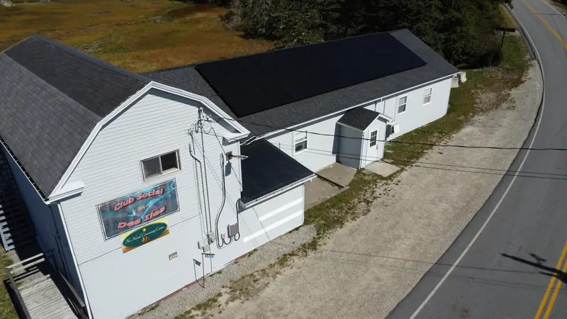 The hall's front gable with the solar array on the main roof behind