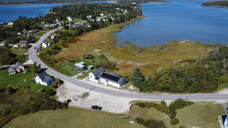 Wide aerial of Surettes Island with the hall, the road and the harbour